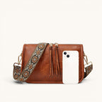ZOFIA ATELIER FELICJA tote bag in brown PU leather with a decorative embroidered strap and tassel details.