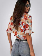 ZOFIA ATELIER floral long sleeve blouse with notched collar, featuring red, orange, and blue abstract floral print on a white background.