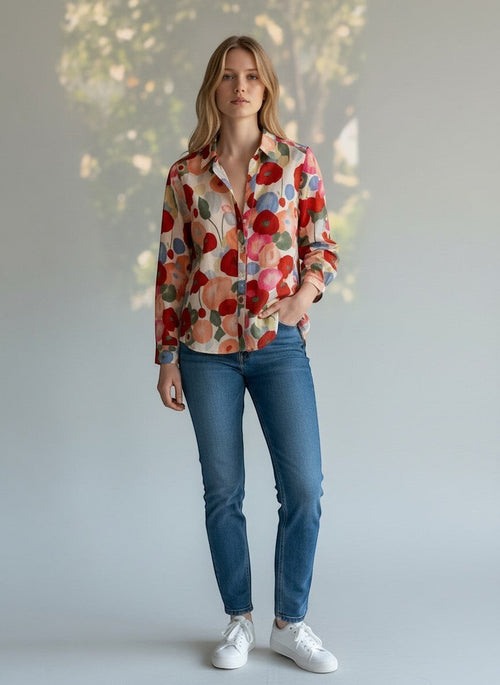ZOFIA ATELIER long sleeve blouse with a vibrant floral print in red, orange, and blue on a cream background. Notched collar.