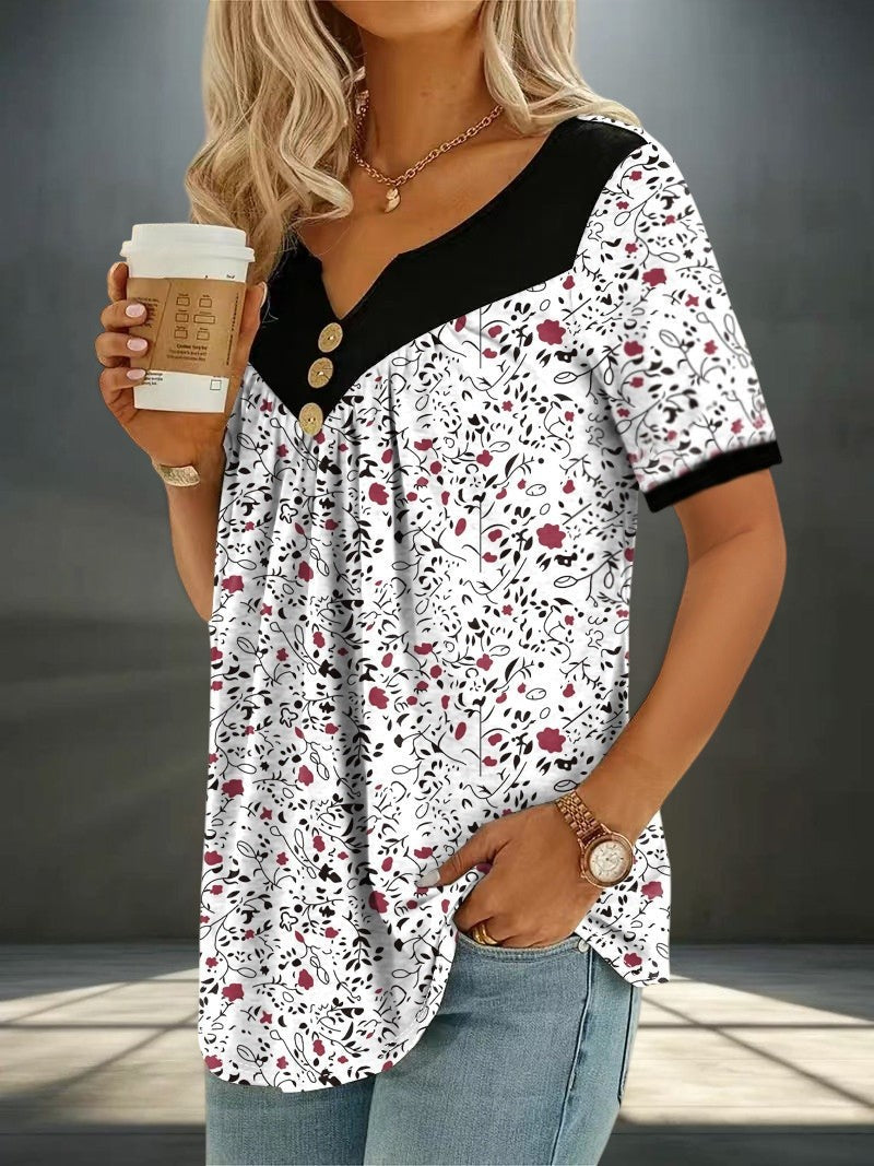 ZOFIA ATELIER white floral print v-neck short sleeve top with black contrast and button detail. Lightweight, flowy fabric.