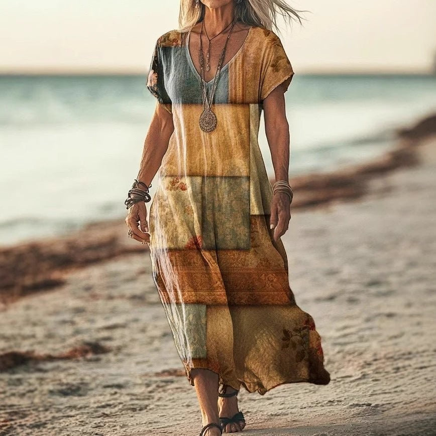 ZOFIA ATELIER Gabrysia floral V-neck midi dress in tan, brown, and blue patchwork print. Flowing, lightweight fabric with short sleeves.
