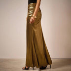ZOFIA ATELIER gold pleated long skirt with ruched detail and subtle vertical stripes, made of polyester.