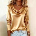 ZOFIA ATELIER Agnieszka draped boat neck top in gold satin with long sleeves, styled with light wash jeans.