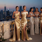 ZOFIA ATELIER gold satin woven dress with oblique shoulder, high slit, and flowing skirt. Model on rooftop.