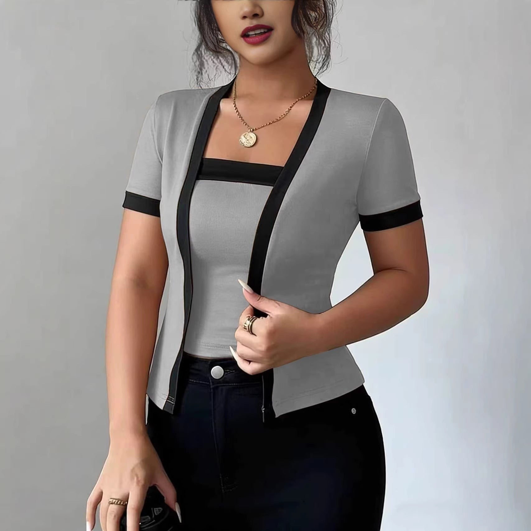 ZOFIA ATELIER gray faux two-piece cardigan with black trim and short sleeves, made of spandex.