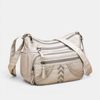 ZOFIA ATELIER GRAŻYNA multi-layer crossbody bag in light gray PU leather with braided accents and stud details.