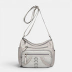 ZOFIA ATELIER light gray multi-layer PU crossbody bag with braided detail and silver studs.