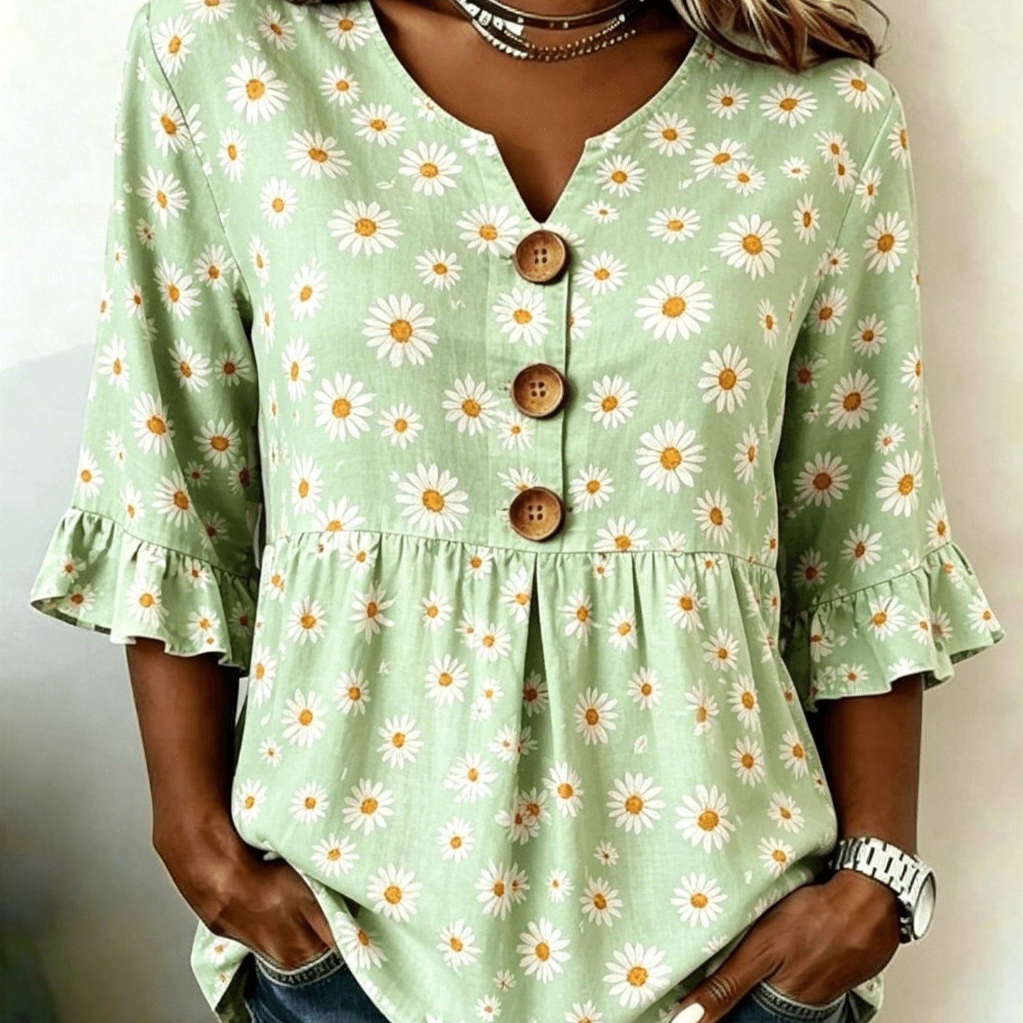 ZOFIA ATELIER light green short-sleeved top with white daisy print, V-neck, button-up front, and ruffled sleeves.