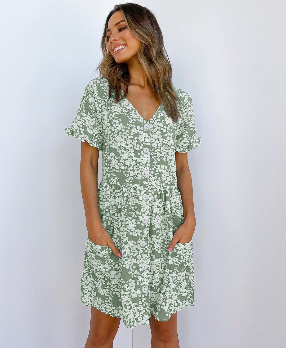 ZOFIA ATELIER green floral print mini dress with V-neck, short sleeves, and button front. Features pockets and a loose waist.