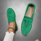 ZOFIA ATELIER green suede loafers with tassel detail and white sole. Slip-on style.