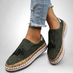 ZOFIA ATELIER green artificial PU tassel round toe flats with cork-effect sole and white stitching.