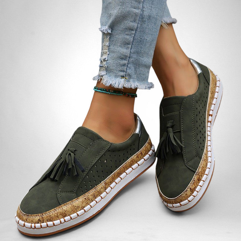 ZOFIA ATELIER green artificial PU tassel round toe flats with cork-effect sole and white stitching.