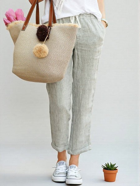 ZOFIA ATELIER light grey linen-blend drawstring pants with cuffed hems, paired with white sneakers.