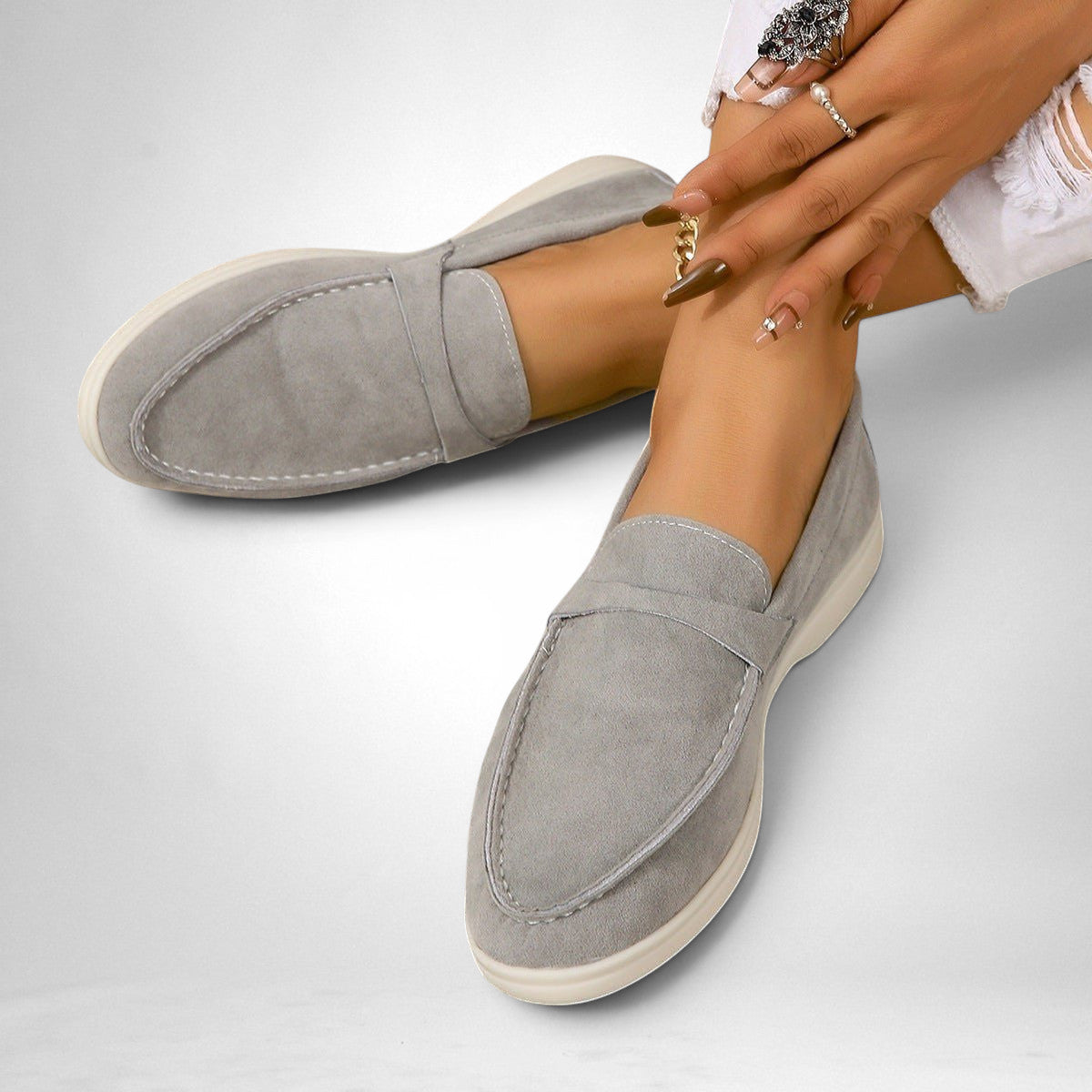 ZOFIA ATELIER grey suede-style slip-on flats with white stitching and a flexible sole. Retro minimalist design.