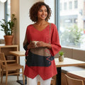 ZOFIA ATELIER HALINA colorblock V-neck top with red, brown, and black panels and decorative stitching.