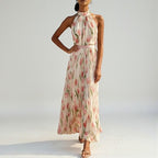 ZOFIA ATELIER WIKTORIA halter swing maxi dress in cream with pink floral print, pleated skirt, and pink sash.