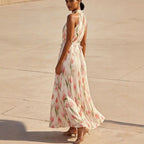 ZOFIA ATELIER WIKTORIA halter swing maxi dress with pink floral print and pleated skirt.