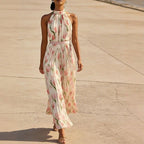 ZOFIA ATELIER WIKTORIA halter swing maxi dress with pink tulip print, pleated skirt, and pink sash.
