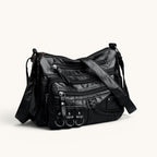 ZOFIA ATELIER HELENA luxury crossbody bag in black PU leather with multiple zippered pockets and braided detail.