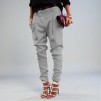 ZOFIA ATELIER light grey polyester blend high waist harem pants with pleats and cuffed ankles.