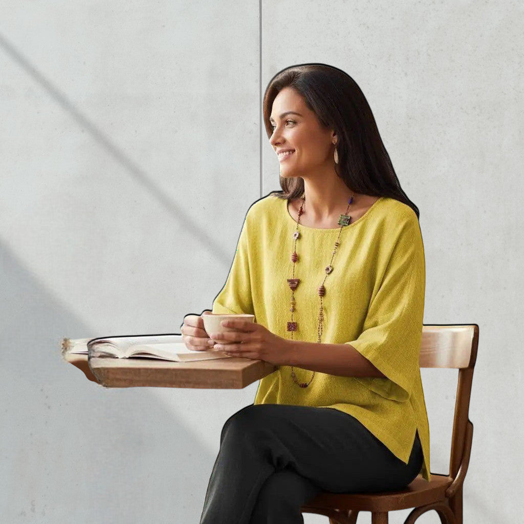 ZOFIA ATELIER Irena yellow linen blend blouse with 3/4 sleeves and a relaxed fit, worn by a woman at a cafe.