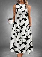 ZOFIA ATELIER Isabella sleeveless floral print midi dress in black and white polyester with pockets.