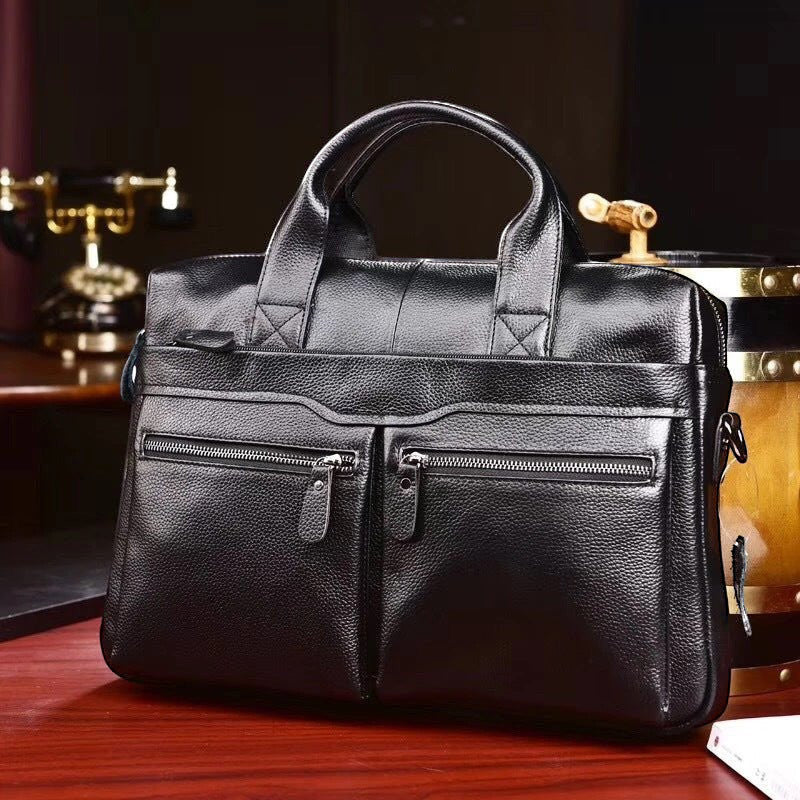 ZOFIA ATELIER KAROLINA minimalist black leather handbag with double front zip pockets and top handles.