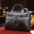 ZOFIA ATELIER KAROLINA minimalist black leather handbag with double front zip pockets and top handles.