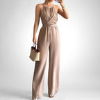 ZOFIA ATELIER khaki polyester sleeveless halter neck jumpsuit with cinched waist and wide legs.