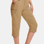 ZOFIA ATELIER Khaki PVC capri pants with asymmetric patchwork design and zippered cargo pocket.