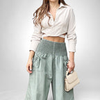 ZOFIA ATELIER beige long-sleeve cropped shirt with white buttons and light green high-waisted ruffled pants.