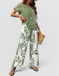 ZOFIA ATELIER green and white leaf print polyester pants set with draped top and three-quarter sleeves.