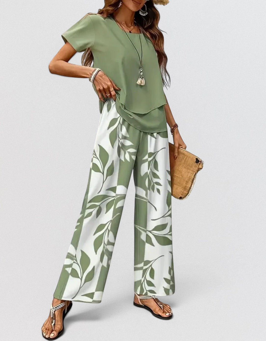 ZOFIA ATELIER green and white leaf print polyester pants set with draped top and three-quarter sleeves.
