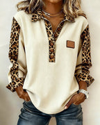 ZOFIA ATELIER cream knitted shirt with leopard print sleeves and collar, button-up front, and patch detail.
