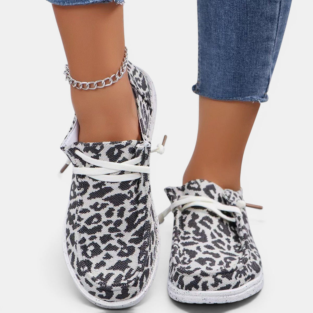 ZOFIA ATELIER leopard print flyknit flats with round toe and white lace-up front.