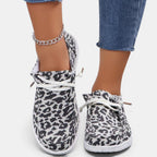 ZOFIA ATELIER leopard print flyknit flats with round toe and white lace-up front.