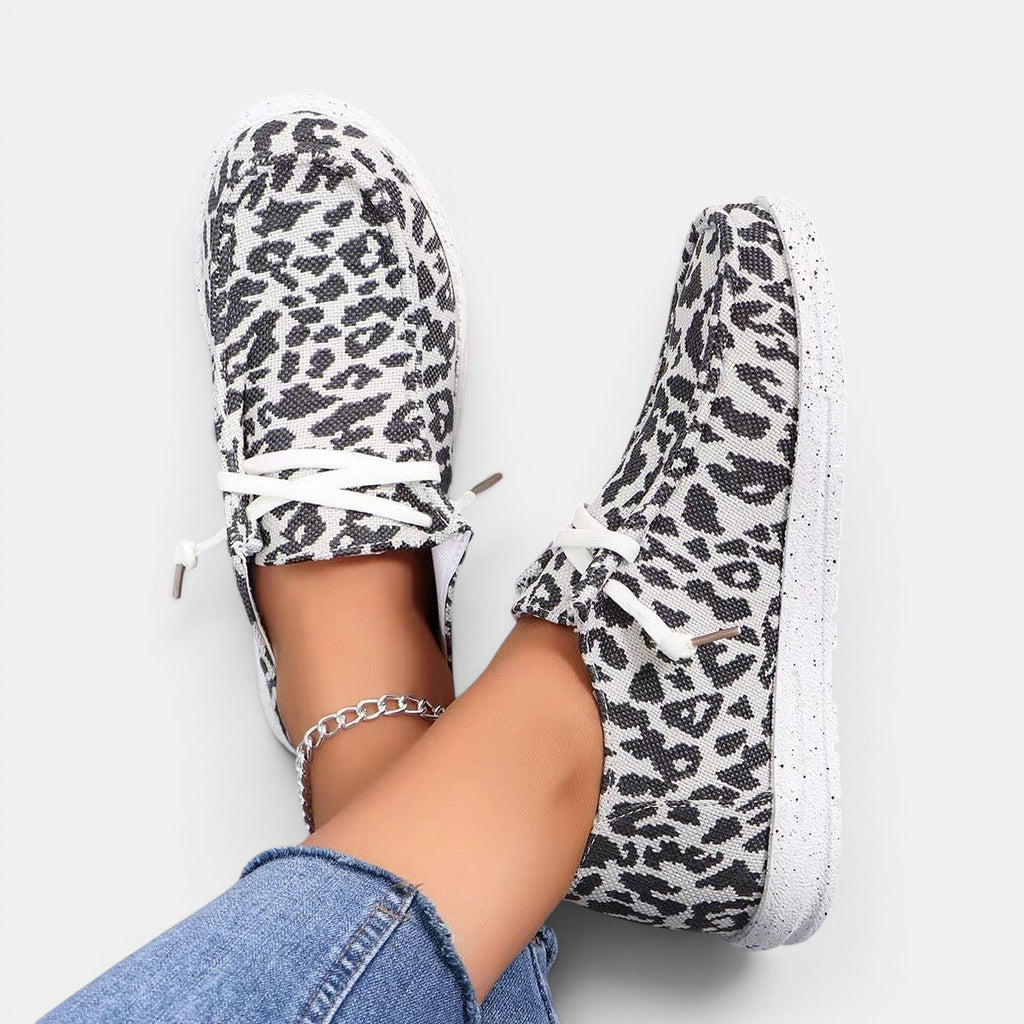 ZOFIA ATELIER leopard print flyknit flats with round toe and white lace-up front.