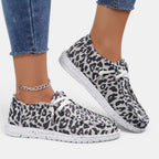 ZOFIA ATELIER leopard print flyknit flats with white laces and round toe.