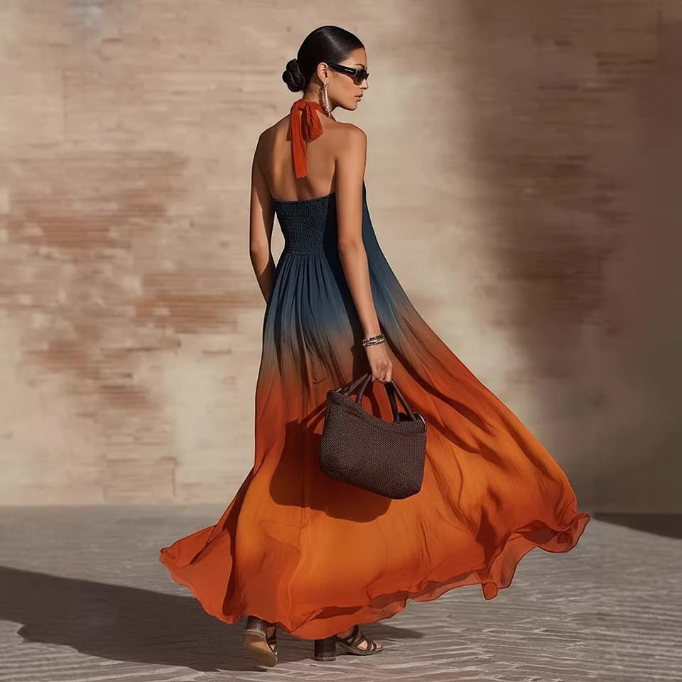 ZOFIA ATELIER Leticia orange floral ombre halter maxi dress with smocked bodice and flowing skirt.