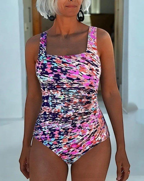 ZOFIA ATELIER Lidia one-piece swimsuit with a colorful abstract print, square neckline, and ruched sides.