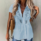 ZOFIA ATELIER light blue short-sleeved rayon and polyester blouse with embroidered hollow-out floral details.
