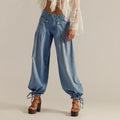 ZOFIA ATELIER light blue cotton loose mid-waist jeans with cinched ankles and tie details.