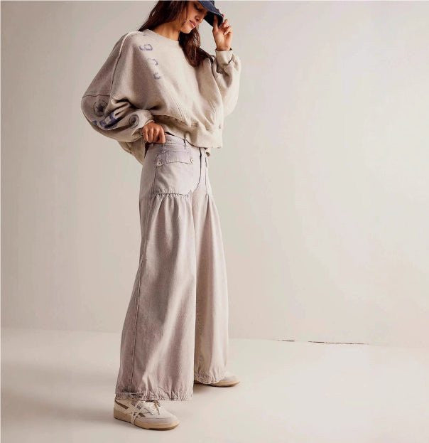 ZOFIA ATELIER light wash loose mid-waist cotton jeans with a wide leg and distressed details.