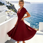 ZOFIA ATELIER Lucia V-neck wrap dress in deep red polyester-ammonia blend with short sleeves and flowing skirt.