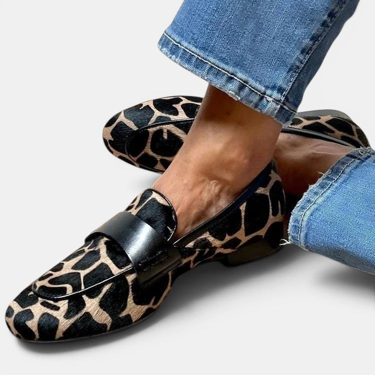 ZOFIA ATELIER Marta loafers in giraffe print with black strap detail and round toe.