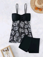 ZOFIA ATELIER MARTA mesh waist swim set with black top and black shorts featuring a white leaf print overlay.