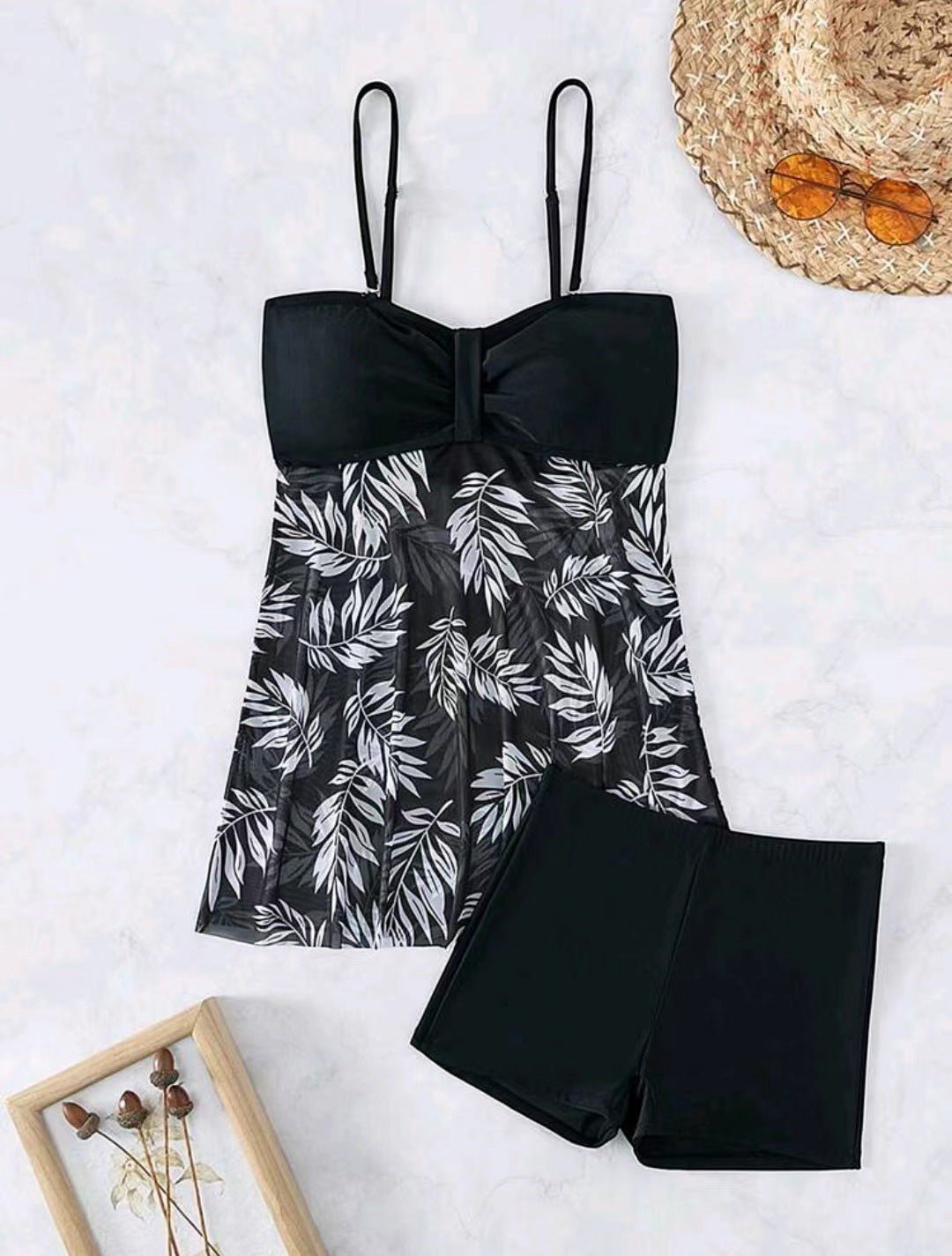 ZOFIA ATELIER MARTA mesh waist swim set with black top and black shorts featuring a white leaf print overlay.