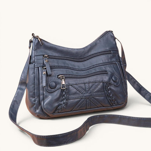 ZOFIA ATELIER AGNIESZKA dark grey PU leather messenger bag with multiple zippered pockets and braided detail.