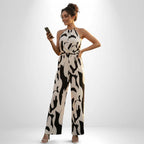 ZOFIA ATELIER white and black milk-stripe halter jumpsuit with wide-leg pants and elastic waist.