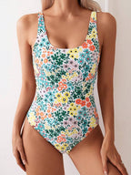 ZOFIA ATELIER Nadia backless sculpt swimsuit in a white floral print with green, yellow, and orange flowers.